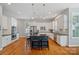 Stylish kitchen with stainless steel appliances, large island, and white cabinetry at 15830 Waterfront Dr, Huntersville, NC 28078