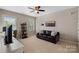 Comfortable living room with a leather couch, bookshelf and large window providing natural light at 15830 Waterfront Dr, Huntersville, NC 28078