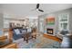 Open-concept living space featuring a fireplace, hardwood floors, and seamless flow into the kitchen and dining area at 15830 Waterfront Dr, Huntersville, NC 28078