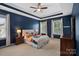 Spacious main bedroom featuring a tray ceiling, large windows, and plush carpeting at 15830 Waterfront Dr, Huntersville, NC 28078