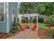 Outdoor living area with brick patio, pergola and seating surrounding a fire pit at 15830 Waterfront Dr, Huntersville, NC 28078