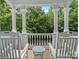 Covered porch view with rocking chairs and serene wooded scenery at 15830 Waterfront Dr, Huntersville, NC 28078