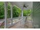 Inviting porch with rocking chairs and ceiling fan, perfect for relaxing and enjoying the outdoors at 15830 Waterfront Dr, Huntersville, NC 28078
