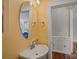 Stylish powder room with round mirror, vessel sink, and custom cabinet at 15830 Waterfront Dr, Huntersville, NC 28078