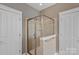 Walk-in tiled shower with seamless glass doors and modern fixtures at 15830 Waterfront Dr, Huntersville, NC 28078
