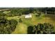 Aerial view featuring a beautiful home, pristine lawn, and surrounding wooded areas at 164 Vance Farm Dr, Statesville, NC 28625