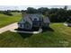 Beautiful aerial view of the property showcasing the manicured lawn and stone and siding home at 164 Vance Farm Dr, Statesville, NC 28625