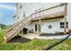 The backyard has an entertainment area with a grill and a wooden stairway to the second floor at 164 Vance Farm Dr, Statesville, NC 28625