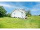 Expansive backyard with lush lawn and a multi-story home featuring a deck and stairs at 164 Vance Farm Dr, Statesville, NC 28625