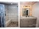 Bathroom featuring wood paneling, tiled shower with built-in seat, and modern vanity at 164 Vance Farm Dr, Statesville, NC 28625