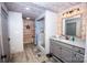 Bathroom featuring wood paneling, modern vanity, and tiled shower at 164 Vance Farm Dr, Statesville, NC 28625