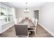 Bright dining room with hardwood floors, a wooden table with seating for eight, and natural light at 164 Vance Farm Dr, Statesville, NC 28625