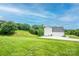 View of the side and back of the house with a long driveway and ample lawn space at 164 Vance Farm Dr, Statesville, NC 28625