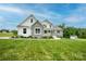 Stunning two-story home featuring stone accents, pristine landscaping, and a lush green lawn at 164 Vance Farm Dr, Statesville, NC 28625