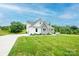 A lovely view of a home with a well-manicured lawn and a long driveway in a rural setting at 164 Vance Farm Dr, Statesville, NC 28625