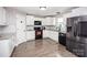 Well-lit kitchen features modern appliances, granite counters, white cabinetry, and tile backsplash at 164 Vance Farm Dr, Statesville, NC 28625
