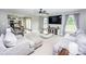 Spacious living room with gray sofas, a modern ceiling fan, and an open view into the adjacent kitchen at 164 Vance Farm Dr, Statesville, NC 28625