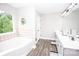 Relaxing main bathroom with soaking tub, double sink vanity, and modern finishes at 164 Vance Farm Dr, Statesville, NC 28625