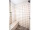 Tiled shower features a built-in seat, convenient shelf, and stone flooring at 164 Vance Farm Dr, Statesville, NC 28625