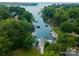 Breathtaking aerial shot capturing a tranquil waterway lined with docks and lush greenery, offering direct water access at 20000 Schooner Dr, Cornelius, NC 28031