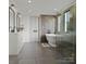 Modern bathroom with a standalone tub, walk-in shower, and double vanity sinks at 20000 Schooner Dr, Cornelius, NC 28031