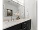 Bathroom featuring dual sinks, modern fixtures, vanity and a large mirror at 20000 Schooner Dr, Cornelius, NC 28031