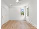 Bedroom with hardwood floors, white trim, and two windows that provide natural light at 20000 Schooner Dr, Cornelius, NC 28031