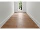 A pristine bedroom features hardwood floors, crown molding, and a window at 20000 Schooner Dr, Cornelius, NC 28031