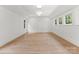 A spacious bedroom features hardwood floors, three windows, and recessed lighting at 20000 Schooner Dr, Cornelius, NC 28031