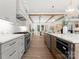 Modern kitchen featuring white cabinetry, stainless steel appliances, a center island, and an open layout to the dining area at 20000 Schooner Dr, Cornelius, NC 28031