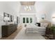 Light and airy main bedroom featuring large windows, tray ceiling, modern lighting, and stylish decor at 20000 Schooner Dr, Cornelius, NC 28031