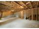 Spacious unfinished basement with exposed ceiling, concrete walls, and wooden studs, ready for customization and expansion at 2033 Camp Greene St, Charlotte, NC 28208