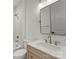 Elegant bathroom featuring a modern vanity with gold fixtures, bathtub, and tiled walls at 2033 Camp Greene St, Charlotte, NC 28208