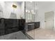 Luxury bathroom showcasing glass shower, black tile, and a dual sink vanity with gold fixtures at 2033 Camp Greene St, Charlotte, NC 28208