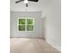 Bright and airy bedroom featuring a large window, light wood floors and white walls at 2033 Camp Greene St, Charlotte, NC 28208