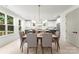 Elegant dining room with ample natural light, a modern chandelier, and an open view into the stylish kitchen at 2033 Camp Greene St, Charlotte, NC 28208