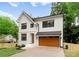 Charming two-story home boasts a modern design, a large garage, and a well-manicured lawn at 2033 Camp Greene St, Charlotte, NC 28208