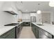 Well-equipped kitchen featuring custom cabinets, stainless steel appliances, and a spacious island with a sink at 2033 Camp Greene St, Charlotte, NC 28208