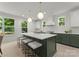 Modern kitchen with a large center island, quartz countertops, stylish stools, and stainless steel appliances at 2033 Camp Greene St, Charlotte, NC 28208