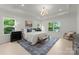 Serene primary bedroom with tray ceiling, hardwood floors, a sitting area, and abundant natural light at 2033 Camp Greene St, Charlotte, NC 28208
