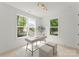 Bright home office featuring large windows with a view of the street, desk and two ottomans at 2033 Camp Greene St, Charlotte, NC 28208