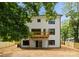 A two-story home shows off it's back exterior with a small deck and partially fenced backyard at 2033 Camp Greene St, Charlotte, NC 28208