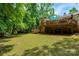 Spacious backyard with mature trees and a large wooden deck, great for relaxing and outdoor gatherings at 2298 Wintercrest Dr, Rock Hill, SC 29732