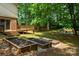 Lush backyard featuring raised garden beds, a fire pit area, and plenty of space for outdoor activities at 2298 Wintercrest Dr, Rock Hill, SC 29732
