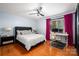 This bedroom features hardwood floors, a ceiling fan, and a built in desk and work space at 2298 Wintercrest Dr, Rock Hill, SC 29732
