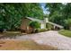 Scenic view of home featuring a gravel driveway, carport, and lush greenery, creating a private retreat at 2298 Wintercrest Dr, Rock Hill, SC 29732