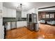 Kitchen with white cabinets, stainless steel appliances, hardwood floors, and a view to the living area at 2298 Wintercrest Dr, Rock Hill, SC 29732