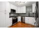 Well-appointed kitchen featuring white cabinets, stainless steel appliances, and hardwood floors at 2298 Wintercrest Dr, Rock Hill, SC 29732