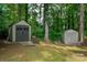 Backyard featuring two storage sheds for lawn equipment and tools, nestled among mature trees at 2298 Wintercrest Dr, Rock Hill, SC 29732