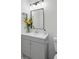 Clean bathroom features a gray vanity with flowers and a large mirror, complemented by a neutral color scheme at 2324 Brookview Ct, Rock Hill, SC 29732